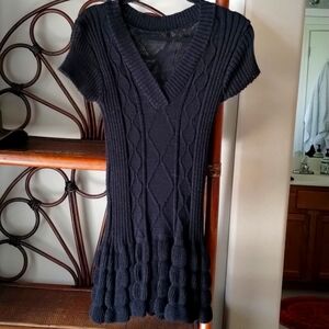 Black cute mini dress. Knitted with bottom refills and short sleeves. Small size